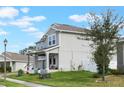 Two-story house with gray siding, two-car garage, and a side yard at 887 Panical Dr, Apopka, FL 32703