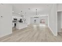 Open floor plan with modern kitchen and wood-look floors at 16895 Sw 50Th Cir, Ocala, FL 34473