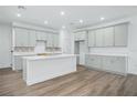 Modern kitchen featuring light gray cabinets, quartz countertops, and an island at 1707 Merthie Dr, Sanford, FL 32771