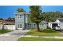 Modern two-story house with gray siding, paver driveway, and landscaped lawn at 1875 Staunton Ave, Winter Park, FL 32789