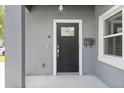 Stylish black front door with a glass insert, complemented by a modern digital lock and a vintage mailbox at 1875 Staunton Ave, Winter Park, FL 32789