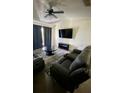 Living room with brown couches, coffee table, and large TV at 1950 Summer Club Dr # 302, Oviedo, FL 32765