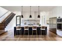 A modern kitchen with an island, marble backsplash, and stainless steel appliances at 2011 University Dr, Orlando, FL 32804