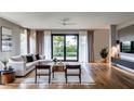 Bright living room boasts a large sliding door, hardwood floors, and contemporary design at 2011 University Dr, Orlando, FL 32804