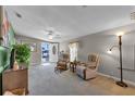 Open living area with two armchairs, a TV, and a view of the entryway at 205 Piedmont Park Ave, Davenport, FL 33897