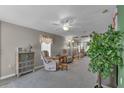 Bright and airy living room featuring two armchairs and a large plant at 205 Piedmont Park Ave, Davenport, FL 33897