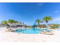 A community swimming pool with a slide and palm trees on a sunny day at 2132 Darlin Cir, Orlando, FL 32820