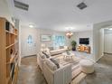 Bright living room features stylish sofas, a coffee table, and a large TV at 224 Alpine St, Altamonte Springs, FL 32701