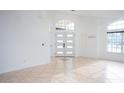 Bright and spacious entrance hall with tile flooring and double doors at 2319 Island Club Way, Orlando, FL 32822