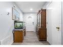 Bright entryway with wood flooring, fish tank, and antique hutch at 2507 Maui Cir, Kissimmee, FL 34741