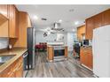 Eat-in kitchen with wood cabinets, granite countertops, and stainless steel appliances at 2507 Maui Cir, Kissimmee, FL 34741