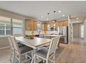 Spacious kitchen featuring light wood cabinets, stainless steel appliances, and an island at 3013 Cherry Blossom Loop, St Cloud, FL 34771