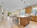 Open kitchen with island, stainless steel appliances, and breakfast bar at 3013 Cherry Blossom Loop, St Cloud, FL 34771