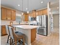 Modern kitchen with stainless steel appliances and light wood cabinets at 3013 Cherry Blossom Loop, St Cloud, FL 34771