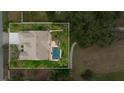 Aerial view of house, pool, and landscape at 3050 Rolling Hills Ln, Apopka, FL 32712