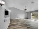 Bright living room with high ceilings and sliding glass doors leading to the backyard at 3201 S Dorchester Dr, Deltona, FL 32738