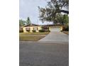 Ranch style home with a brick facade, attached garage, and well-maintained lawn at 3817 Bainbridge Ave, Orlando, FL 32839