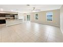 Open floor plan with tile flooring connecting the kitchen and living areas at 4269 Desert Rose Ave, Kissimmee, FL 34746