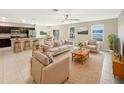 Open living room and kitchen with island and neutral color palette at 4269 Desert Rose Ave, Kissimmee, FL 34746