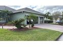 Two-car garage with paver driveway and landscaping at 4726 Combahee Ln, Orlando, FL 32837