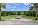 Long driveway leading to home with fountain and palm trees at 5251 Carson St, St Cloud, FL 34771