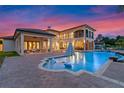 Stunning pool and patio area with outdoor seating at sunset at 5251 Carson St, St Cloud, FL 34771