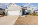 Single story home with white garage door and landscaping at 7518 Sw 77Th Ave, Ocala, FL 34481