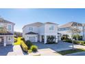 Two-story house with gray siding, two-car garage, and a paved driveway at 7668 Fairfax Dr, Kissimmee, FL 34747