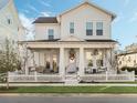 Two-story white house with a front porch and white picket fence at 1175 Celadon St, Oakland, FL 34787