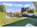 Backyard with pond view and lush landscaping at 12079 Modena Ln, Orlando, FL 32827