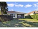 Backyard with screened patio and grassy lawn at 12079 Modena Ln, Orlando, FL 32827