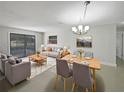 Bright living room features gray sofas, wood coffee table, and dining area at 1319 N Old Mill Dr, Deltona, FL 32725