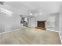 Open living room with a fireplace and kitchen view at 1350 Bailey Ave, Deltona, FL 32725