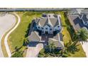 Sprawling two-story home with lush landscaping and a paved driveway with a fountain at 14039 Hampshire Bay Cir, Winter Garden, FL 34787