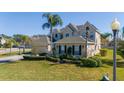 Two-story home featuring manicured landscaping, a two-car garage and decorative shutters at 14039 Hampshire Bay Cir, Winter Garden, FL 34787