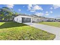New construction home with a modern design and two-car garage at 162 Nw 42Nd Pl, Ocala, FL 34475
