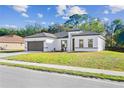 New construction home with a modern design and two-car garage at 162 Nw 42Nd Pl, Ocala, FL 34475