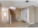 Staircase and entry door in a home with tiled floor at 1647 Bridgeview Cir, Orlando, FL 32824