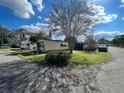 Mobile home exterior with a spacious yard at 1960 Pinewood Ln, Mount Dora, FL 32757