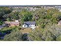 An aerial view of a charming single-story home with a well-maintained lawn and mature trees at 2033 N Orange St, Mount Dora, FL 32757