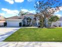 Single-Gathering home with a two-car garage and spacious front yard at 2077 Wembley Pl, Oviedo, FL 32765