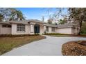 Landscaped yard with curved driveway and a beautiful two-story house with blue front door at 2397 River Tree Cir, Sanford, FL 32771