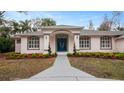 Front entrance of a two-story house with blue door, and neatly landscaped gardens at 2397 River Tree Cir, Sanford, FL 32771