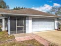 One-story house with a brown roof, attached garage, and screened porch at 2810 Summerfield St, Deltona, FL 32738