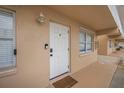 Inviting entrance to unit with white door and neutral color scheme at 3724 S Atlantic Ave # 20, Daytona Beach, FL 32118