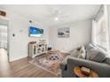 Living room with gray couch, coffee table, and ocean-themed decor at 3724 S Atlantic Ave # 20, Daytona Beach, FL 32118
