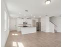 Bright, open-concept living space with tile floors, recessed lighting, and a kitchen view at 4329 Switchgrass Ln, St Cloud, FL 34772