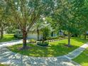 Landscaped yard with mature trees surrounds this charming house at 4938 Raylene Way, St Cloud, FL 34771