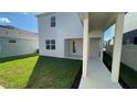 View of the backyard featuring a covered patio, green lawn, and well-kept exterior at 5374 Lake Virginia St, Winter Garden, FL 34787