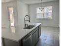 Kitchen island featuring a stainless steel dishwasher, sink, and modern faucet at 5374 Lake Virginia St, Winter Garden, FL 34787